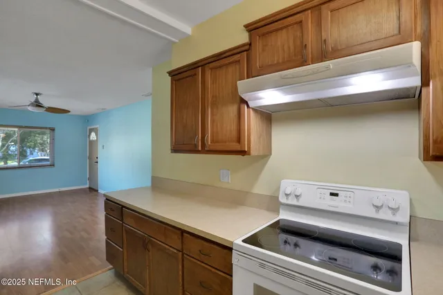an empty room with closet and a chandelier fan