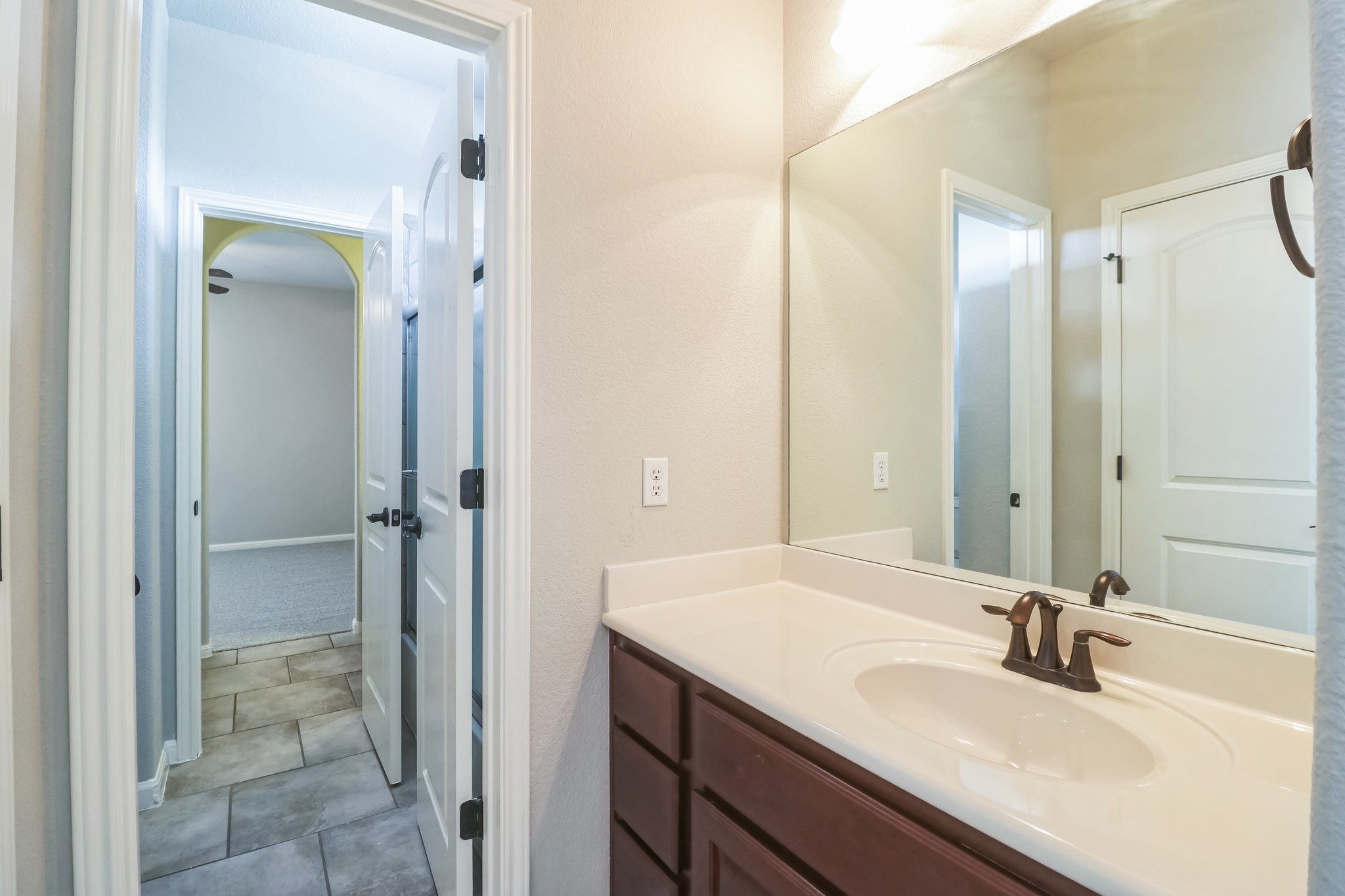 3913 Remington Road Cedar Park, TX 78613 - Photo 19 of 32 A spacious vanity mirror reflects the clean entryway of this modern bathroom space.