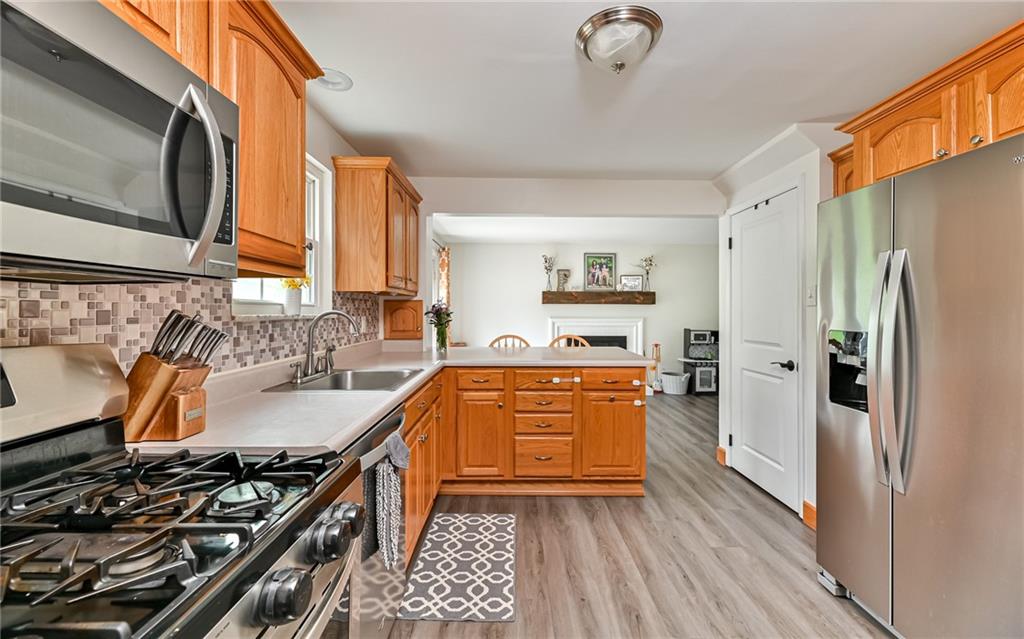 8988 Willoughby Road Pittsburgh, PA 15237 - Photo 11 of 25 a kitchen with stainless steel appliances granite countertop a stove a sink and a refrigerator