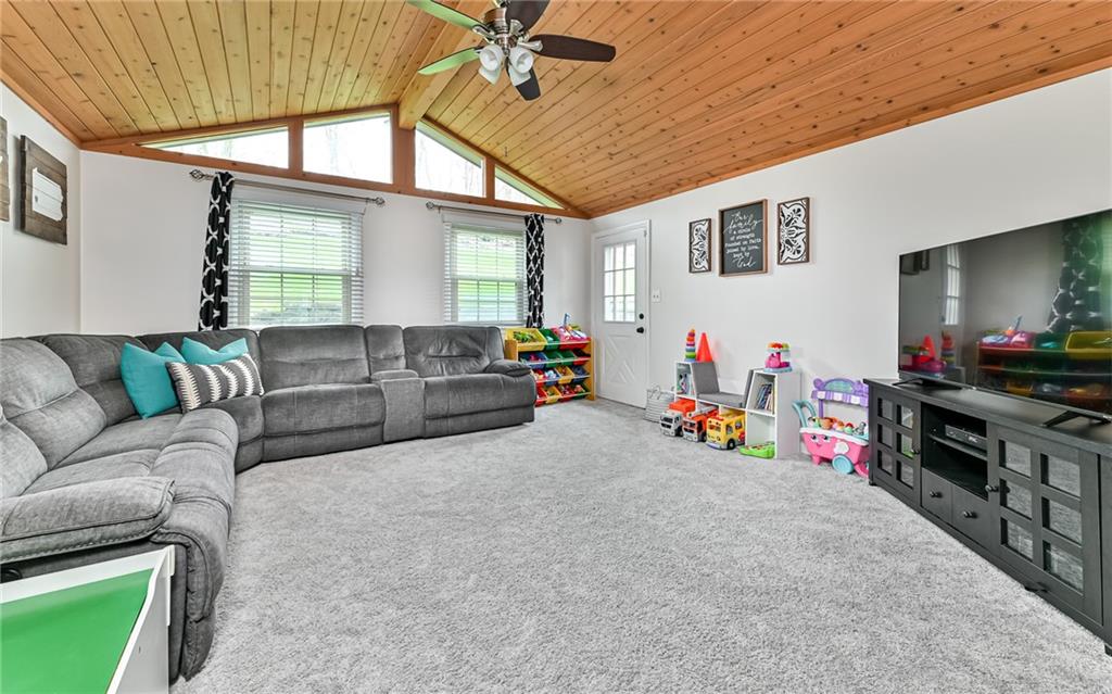 8988 Willoughby Road Pittsburgh, PA 15237 - Photo 14 of 25 a living room with furniture and a flat screen tv