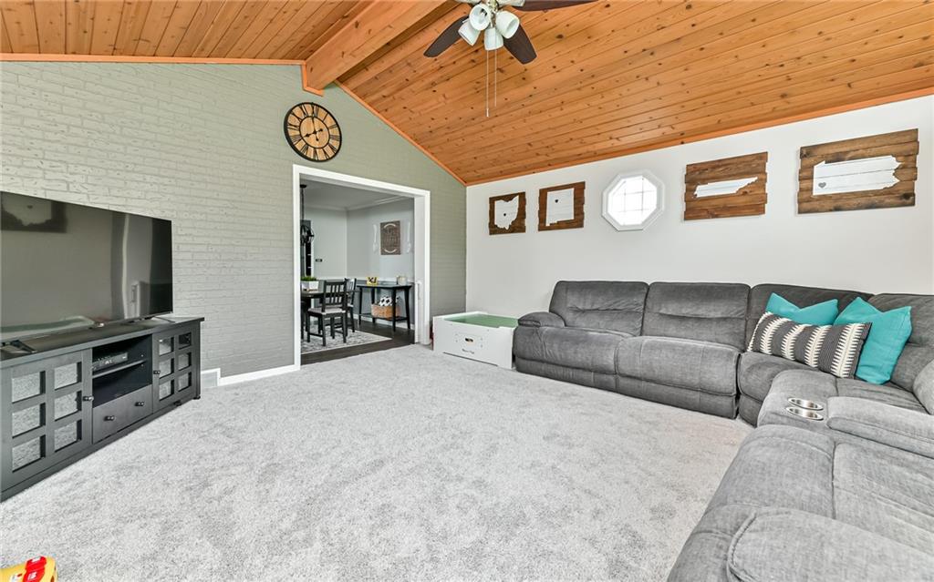 8988 Willoughby Road Pittsburgh, PA 15237 - Photo 15 of 25 a living room with a couch and a flat screen tv