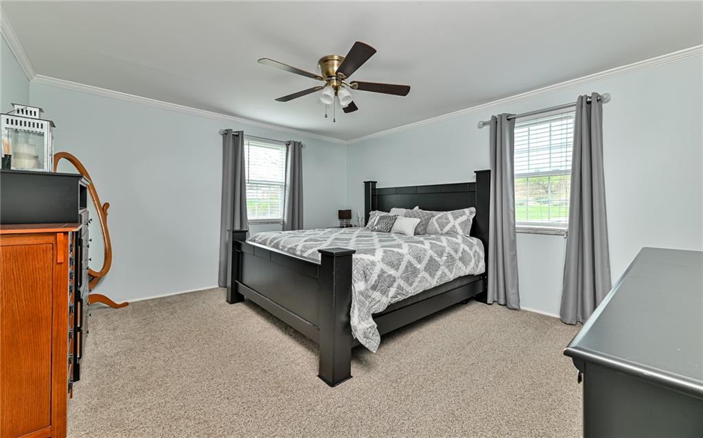 8988 Willoughby Road Pittsburgh, PA 15237 - Photo 17 of 25 a bedroom with a bed and a flat screen tv