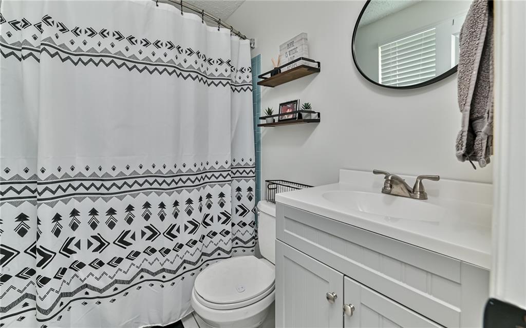 8988 Willoughby Road Pittsburgh, PA 15237 - Photo 18 of 25 a bathroom with a sink a toilet and a mirror