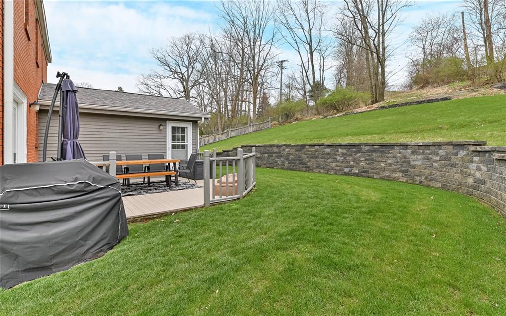 8988 Willoughby Road Pittsburgh, PA 15237 - Photo 24 of 25 a view of a backyard with table and chairs potted plants and a large tree