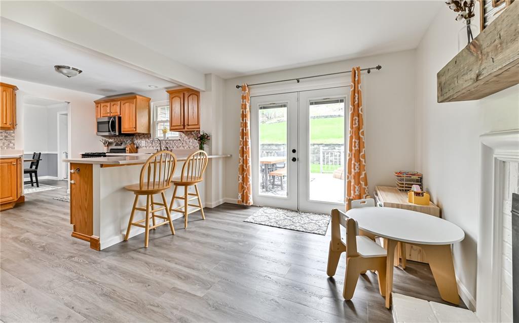 8988 Willoughby Road Pittsburgh, PA 15237 - Photo 9 of 25 a view of a dining room with furniture window and wooden floor