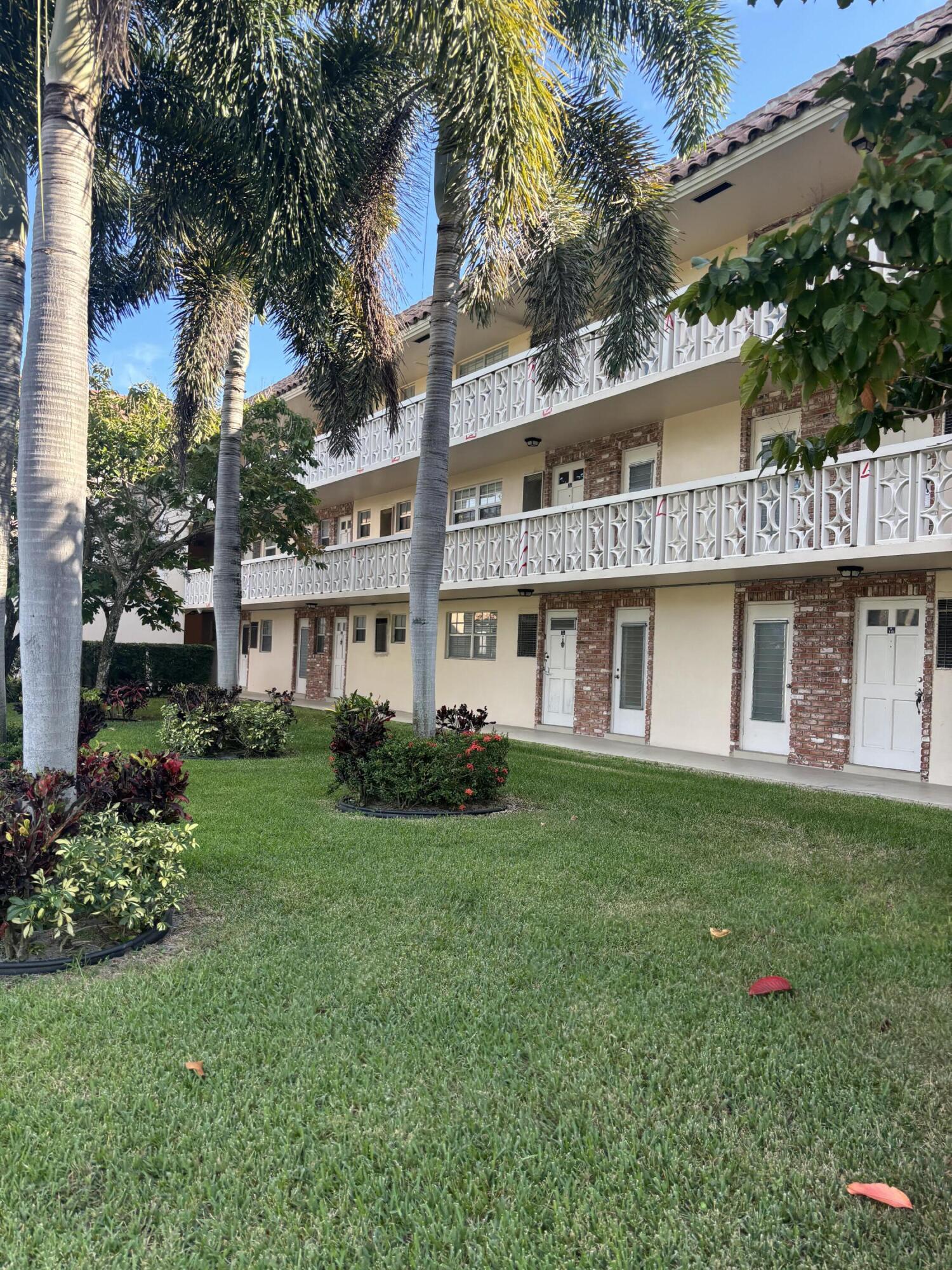 400 Northeast 20th Street, Unit A131 Boca Raton, FL 33431 - Photo 1 of 17 a front view of a house with a garden