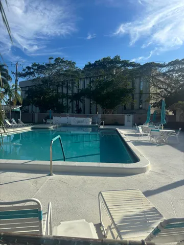 a view of a swimming pool with a table and chairs