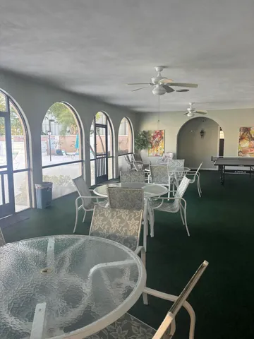 a view of a livingroom with furniture window and wooden floor