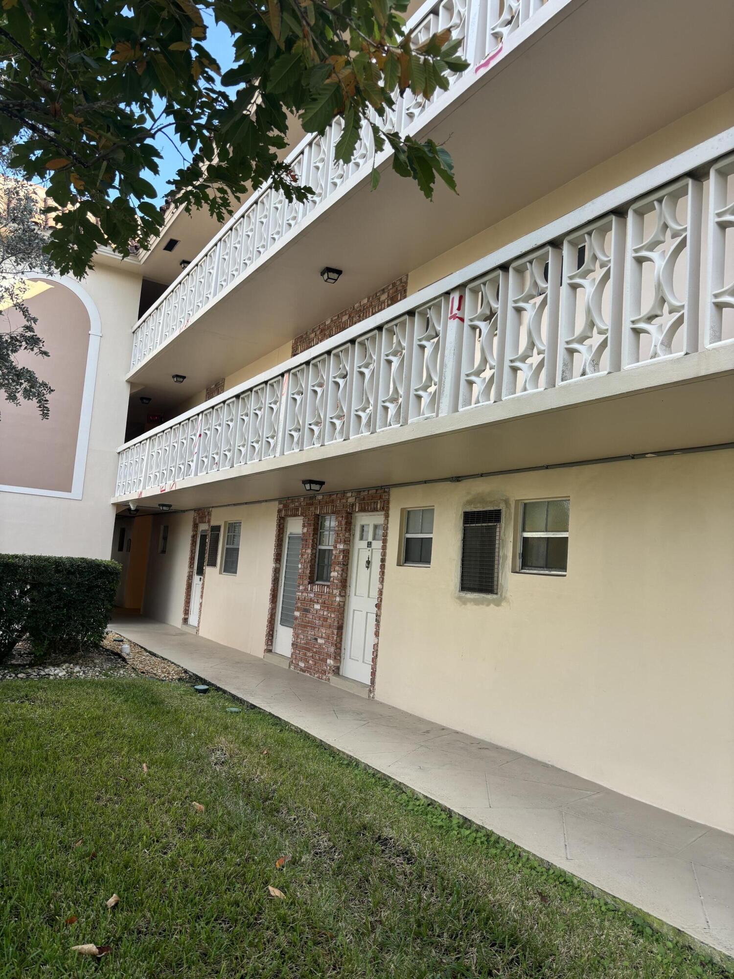 400 Northeast 20th Street, Unit A131 Boca Raton, FL 33431 - Photo 2 of 17 a front view of a house with garden