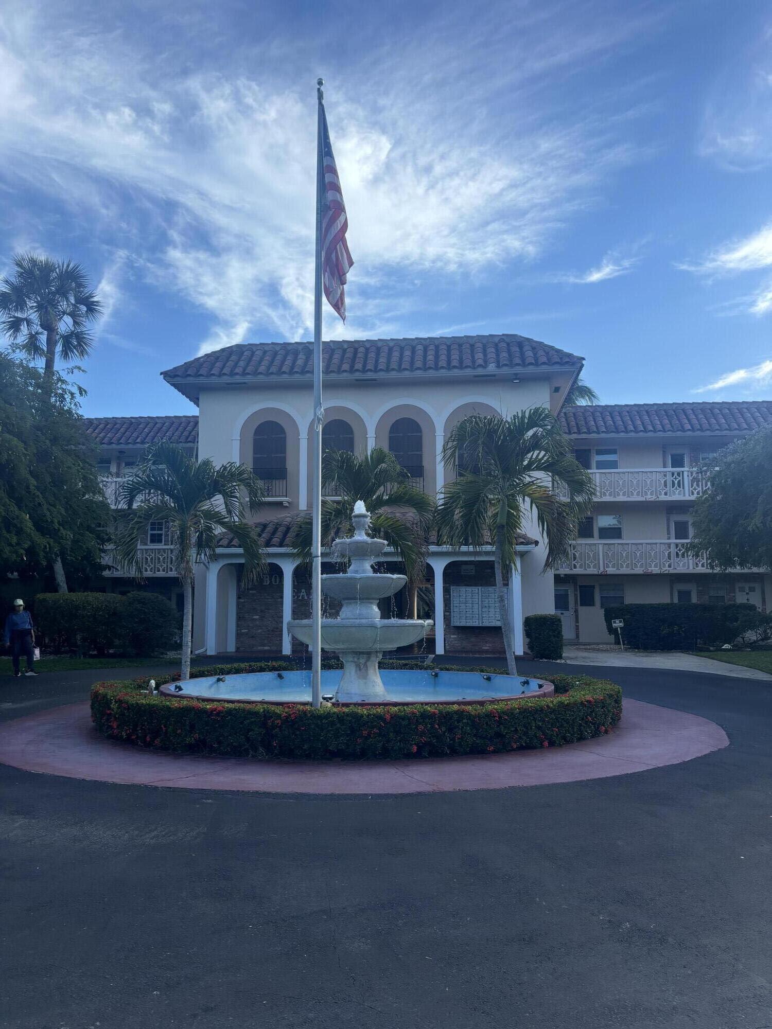 400 Northeast 20th Street, Unit A131 Boca Raton, FL 33431 - Photo 3 of 17 a front view of a house with a garden