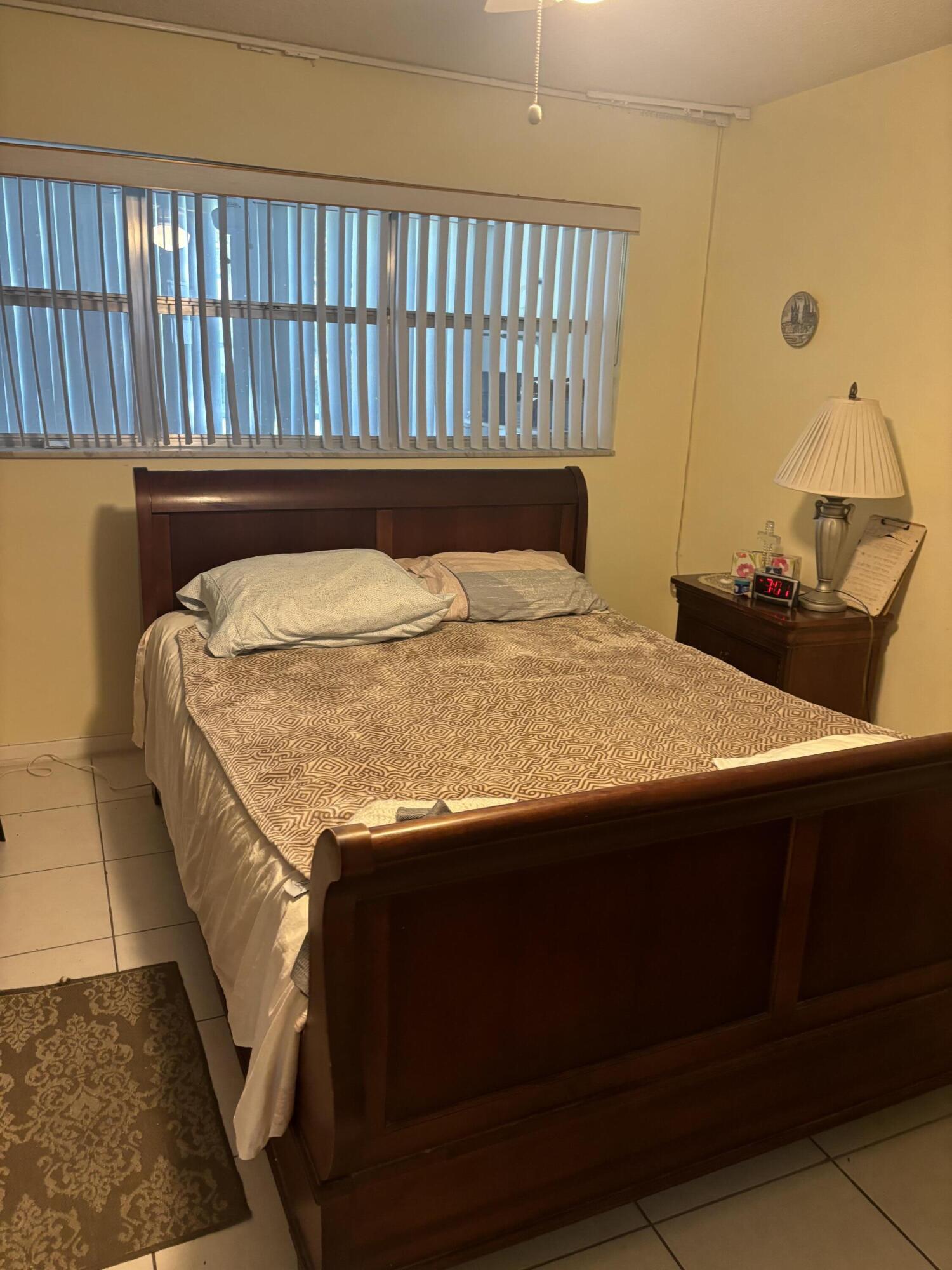 400 Northeast 20th Street, Unit A131 Boca Raton, FL 33431 - Photo 5 of 17 a bed sitting in a bedroom next to a window