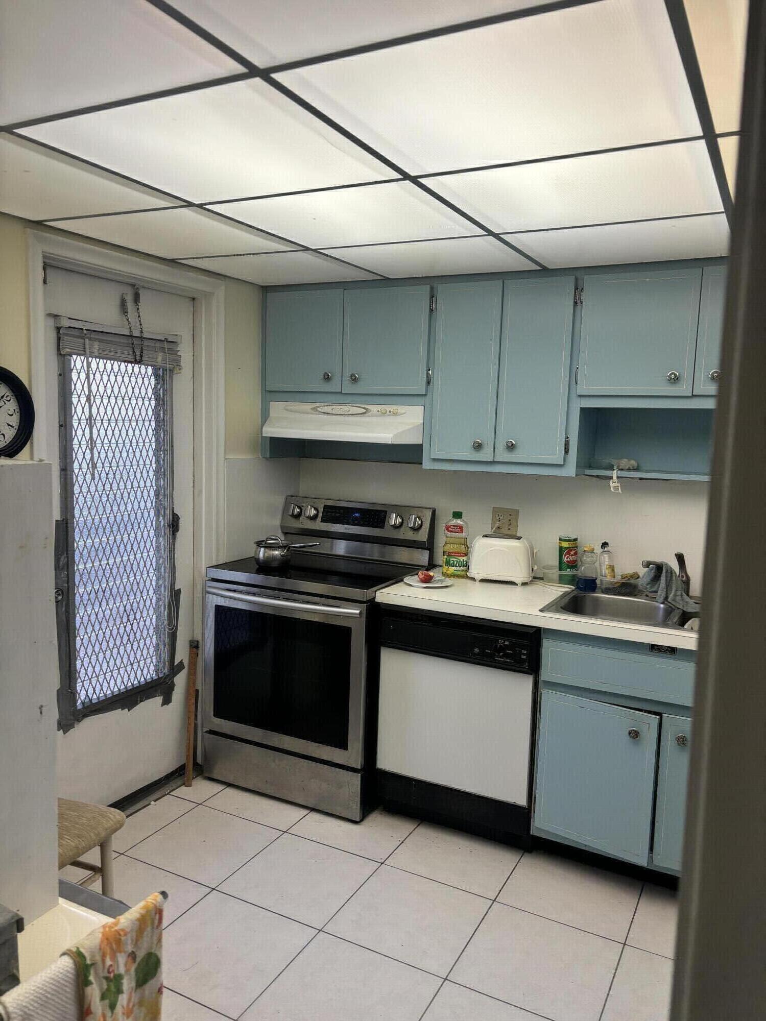 400 Northeast 20th Street, Unit A131 Boca Raton, FL 33431 - Photo 6 of 17 a kitchen with stainless steel appliances granite countertop a stove a sink and a microwave