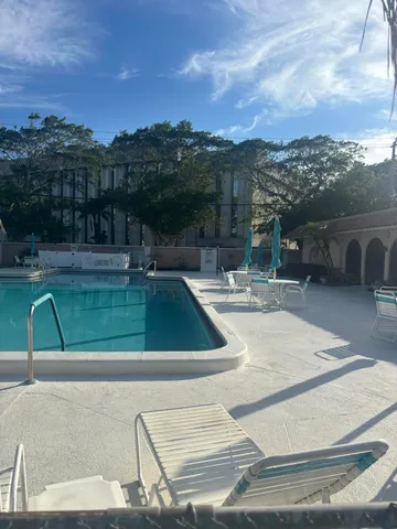 a view of a swimming pool with a lake view and mountain view