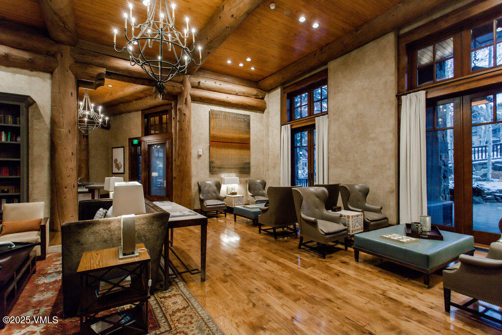 100 Bachelor Ridge Road, Unit 3404/8 Avon, CO 81620 - Photo 12 of 15 a living room with furniture a rug and a chandelier