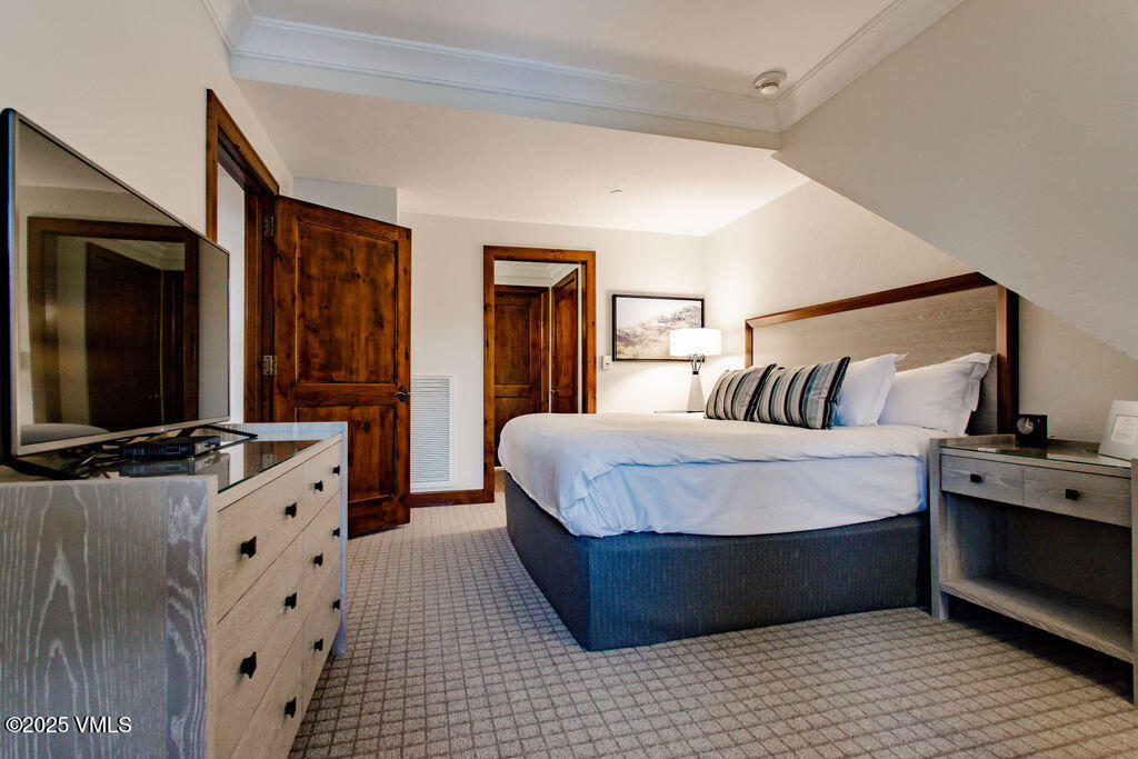 100 Bachelor Ridge Road, Unit 3404/8 Avon, CO 81620 - Photo 5 of 15 a spacious bedroom with a bed and a flat screen tv