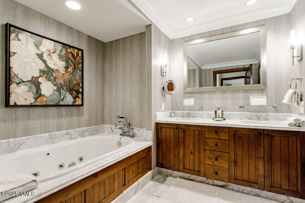 100 Bachelor Ridge Road, Unit 3404/8 Avon, CO 81620 - Photo 7 of 15 a bathroom with a tub a sink and mirror
