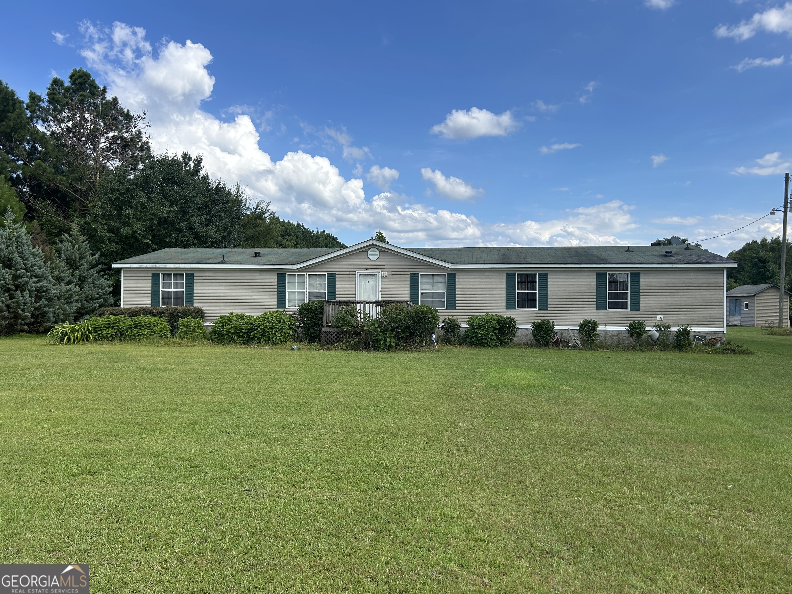 a front view of house with a garden