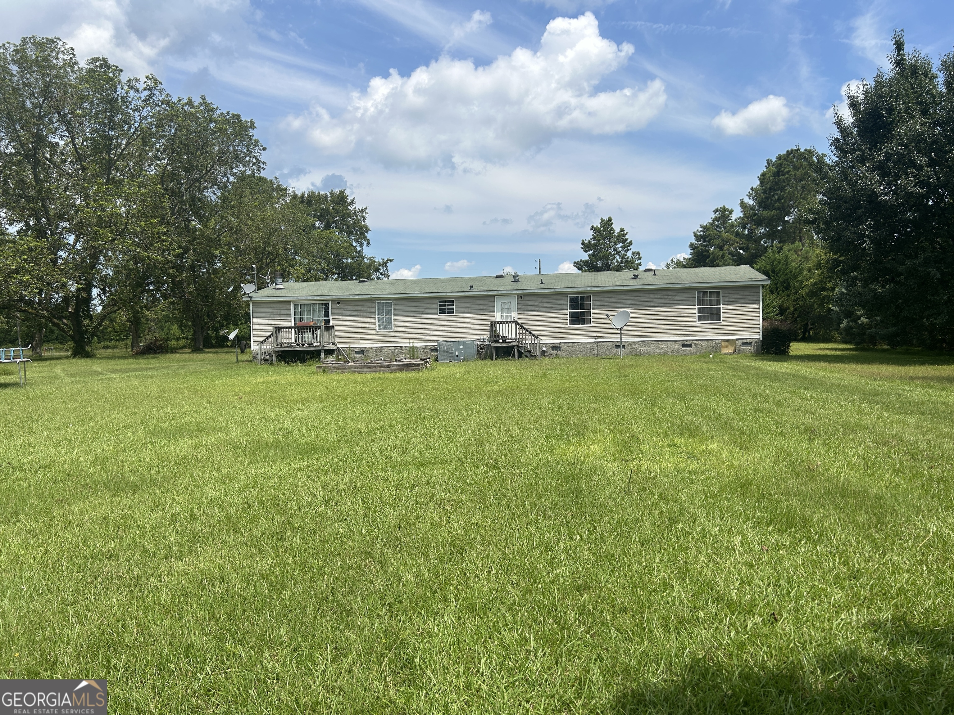 1105 River Road Fort Valley, GA 31030 - Photo 14 of 16 a view of a house with yard and a large tree
