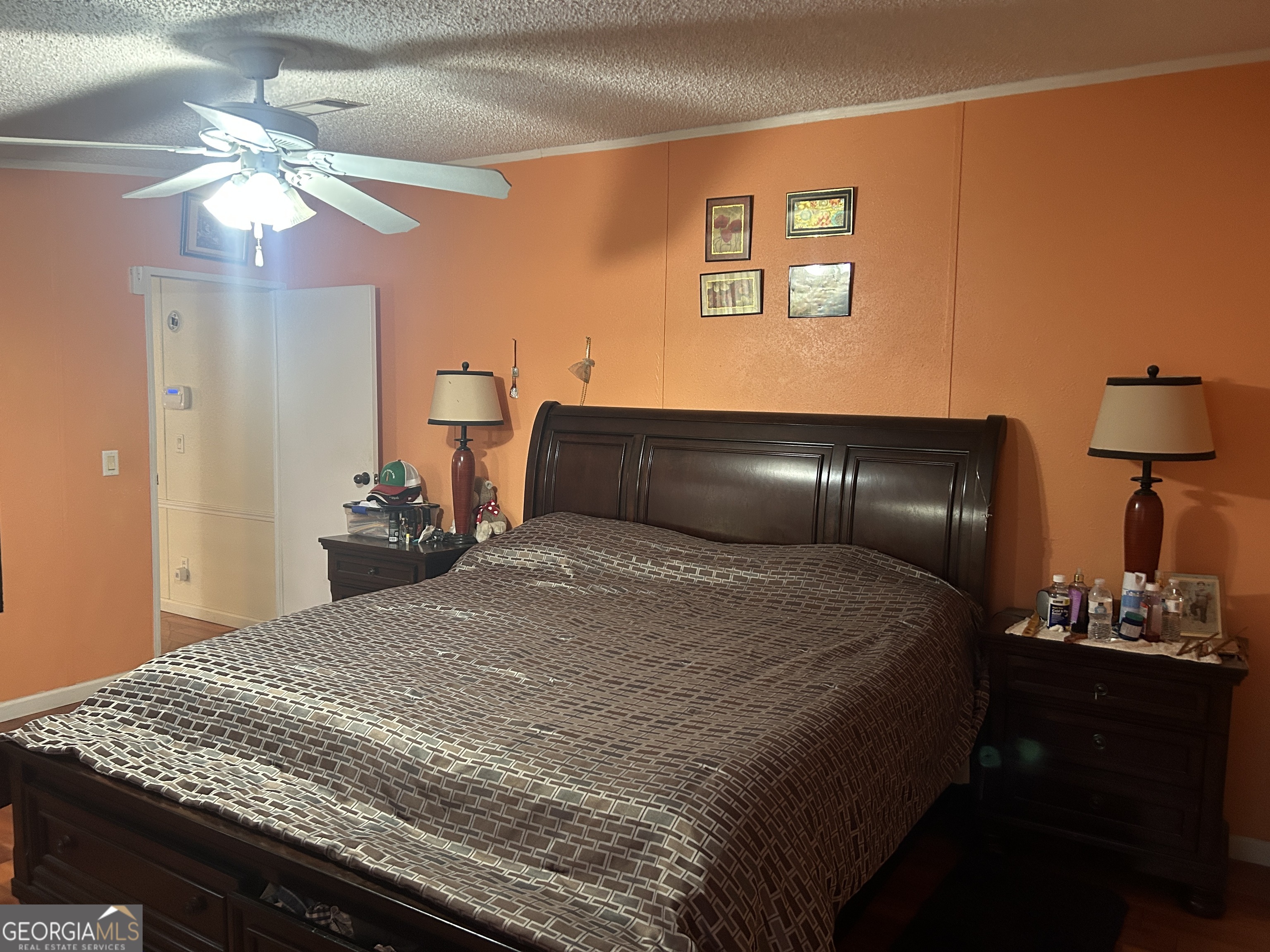 1105 River Road Fort Valley, GA 31030 - Photo 7 of 16 a bedroom with a large bed and a chandelier