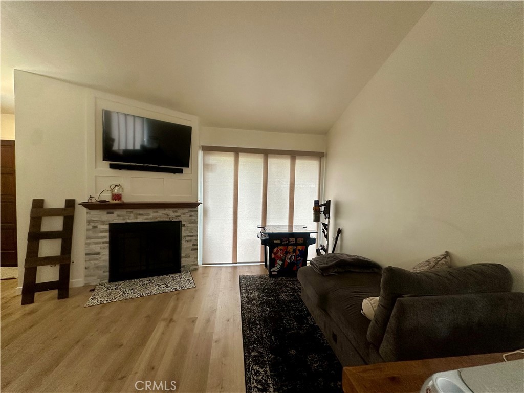 18223 Soledad Canyon Road, Unit 45 Canyon Country, CA 91387 - Photo 23 of 24 a living room with furniture a fireplace and a flat screen tv