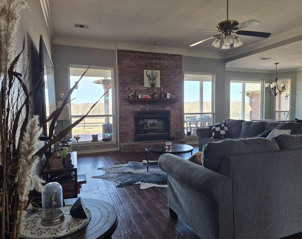 274 County Road Southwest Winnsboro, TX 75494 - Photo 19 of 26 a living room with furniture a chandelier and a fireplace