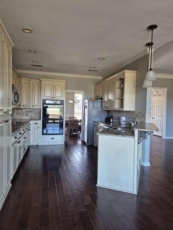 274 County Road Southwest Winnsboro, TX 75494 - Photo 23 of 26 a kitchen with stainless steel appliances granite countertop a stove top oven a sink dishwasher and a refrigerator