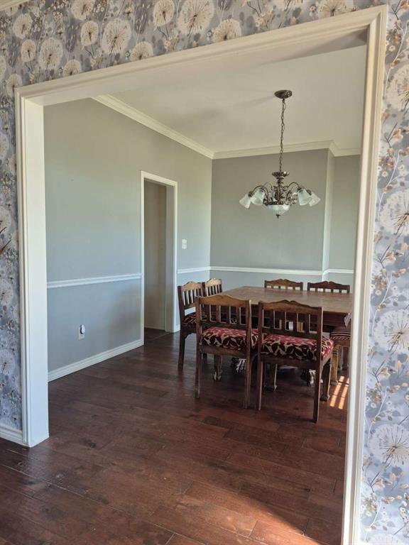 274 County Road Southwest Winnsboro, TX 75494 - Photo 25 of 26 a view of a dining room with furniture wooden floor and chandelier