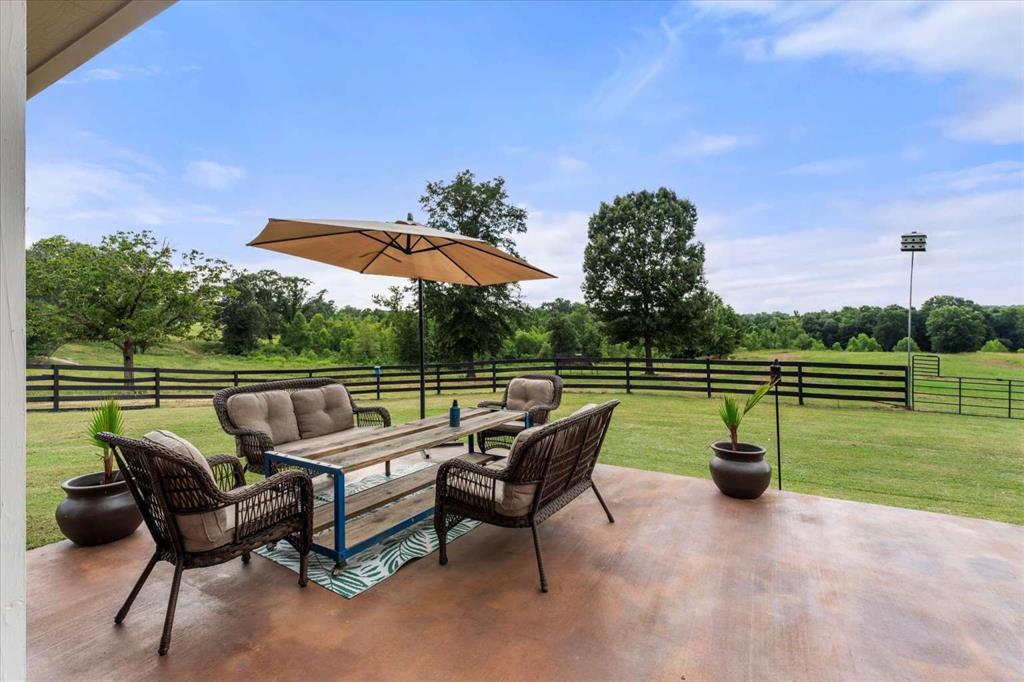 274 County Road Southwest Winnsboro, TX 75494 - Photo 6 of 26 a view of a patio with furniture and a yard