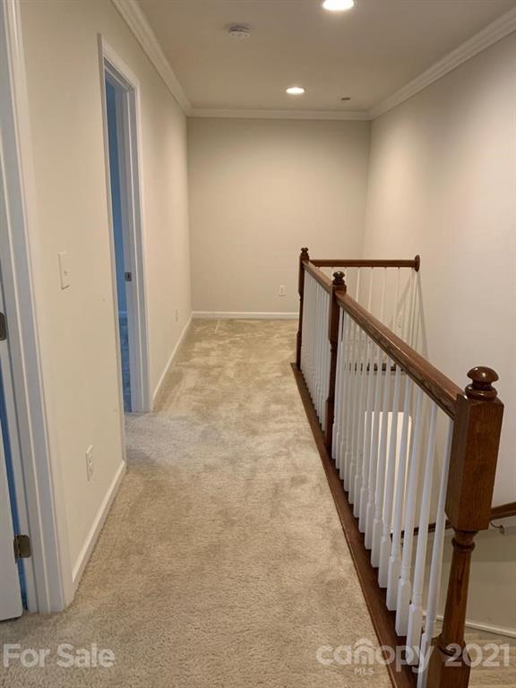 733 Dynamo Street Northwest Concord, NC 28027 - Photo 11 of 24 a view of a hallway with wooden floor and stairs