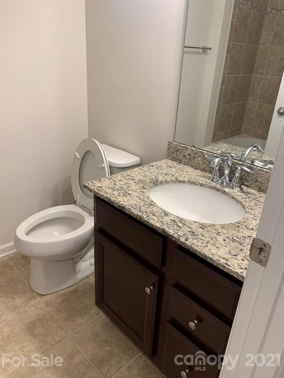 733 Dynamo Street Northwest Concord, NC 28027 - Photo 17 of 24 a bathroom with a granite countertop sink and a mirror