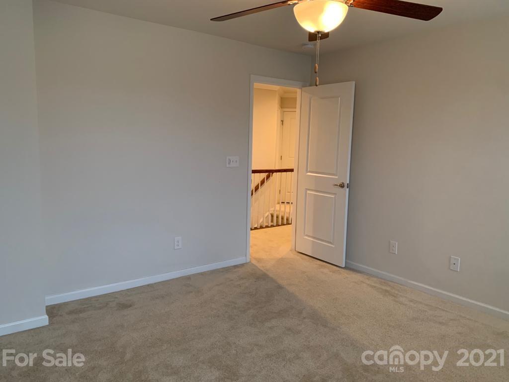 733 Dynamo Street Northwest Concord, NC 28027 - Photo 19 of 24 a view of empty room with a chandelier fan