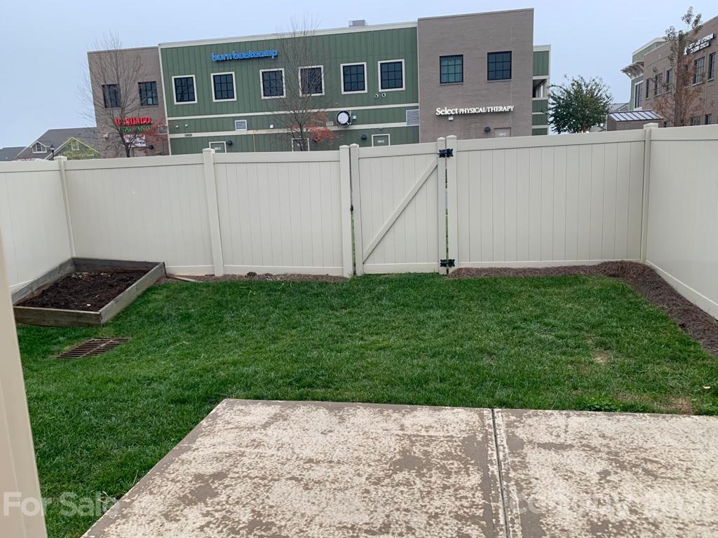 733 Dynamo Street Northwest Concord, NC 28027 - Photo 24 of 24 a view of backyard with barbeque grill and wooden fence
