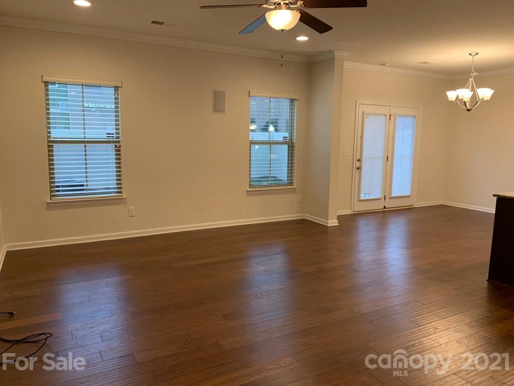 733 Dynamo Street Northwest Concord, NC 28027 - Photo 4 of 24 an empty room with wooden floor and windows