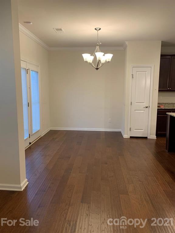733 Dynamo Street Northwest Concord, NC 28027 - Photo 9 of 24 wooden floor in an empty room with a window