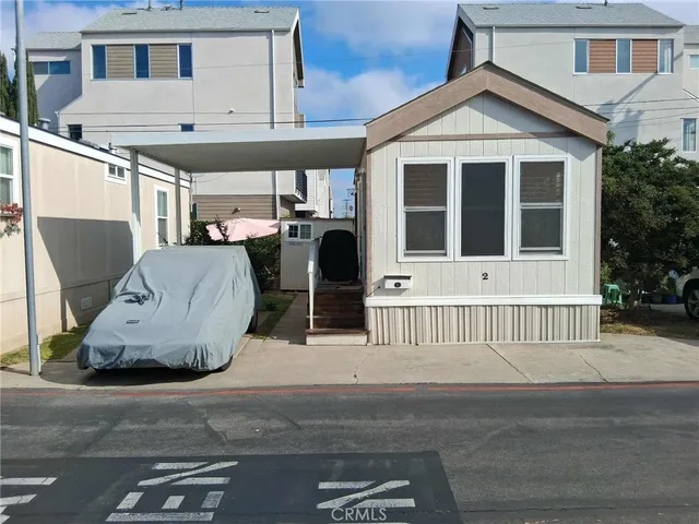 a view of a house with a large window and wooden fence