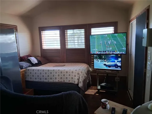 a bedroom with a bed table and window