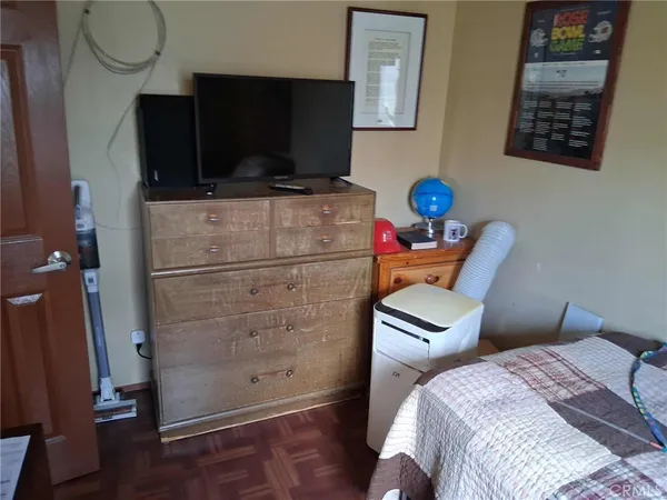 a bedroom with furniture and a window