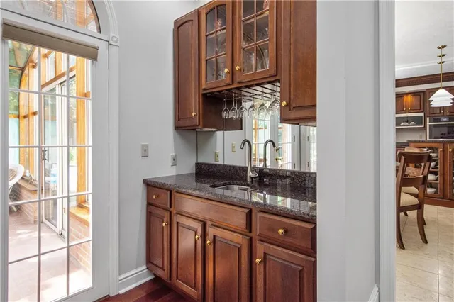 a bathroom with a granite countertop sink a vanity and a window