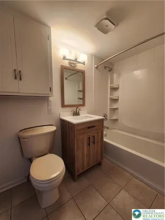a bathroom with a toilet a sink and bathtub