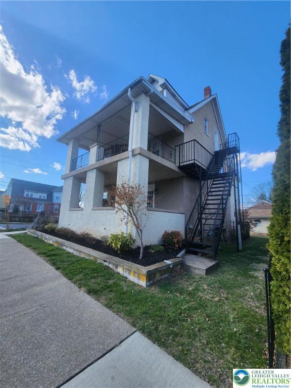 401 East Goepp Street, Unit 2 Bethlehem, PA 18018 - Photo 3 of 16 a view of a white house with a small yard and a large tree