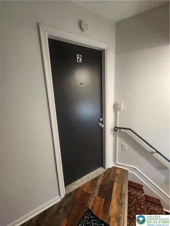a view of bedroom with a bed and wooden floor