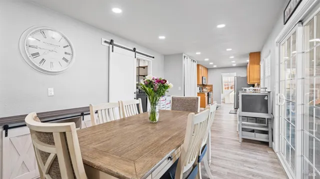 a view of a dining room with furniture and a kitchen