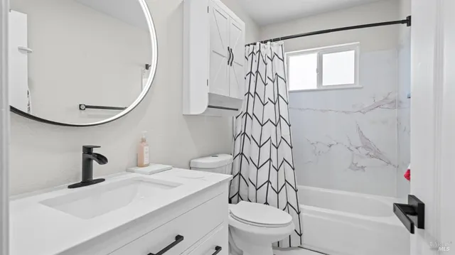 a bathroom with a sink a toilet and a bathtub