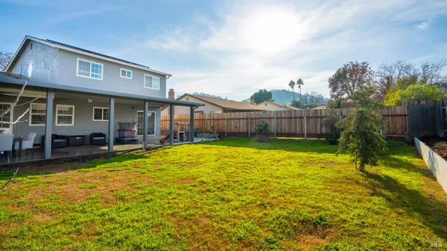 a view of a house with a swimming pool and a yard