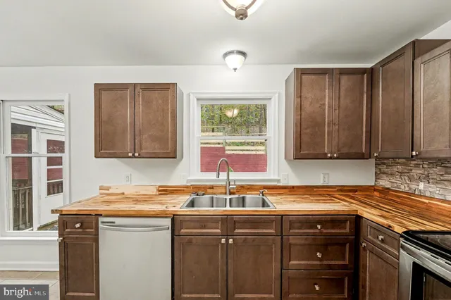 a kitchen that has a sink and a stove