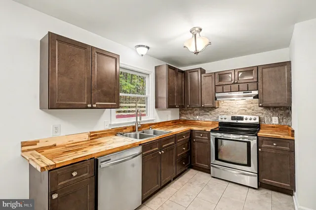 a bathroom with a sink vanity and toilet
