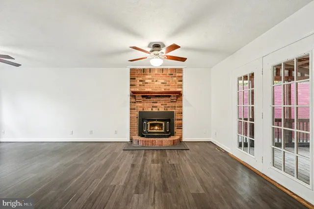 wooden floor in an empty room with a fireplace