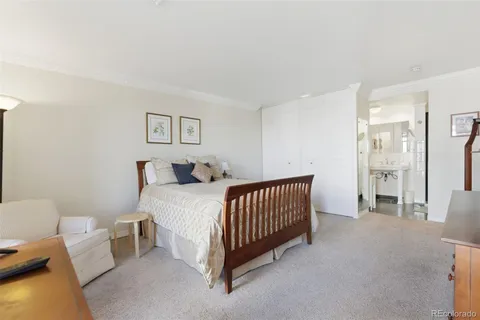 a bedroom with a bed and a lamp