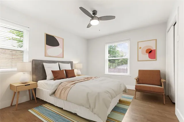 a bedroom with a bed couch and window