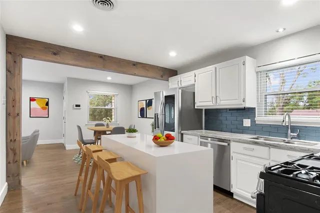 a kitchen with a sink appliances and cabinets